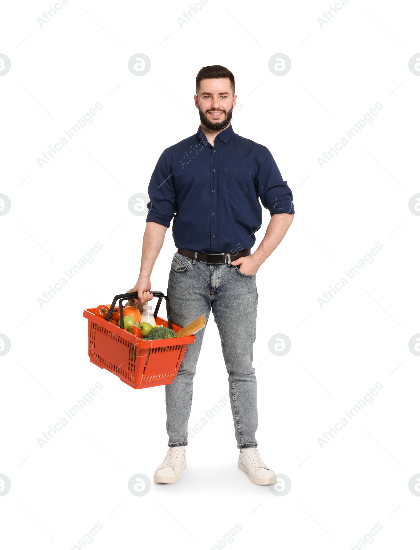 Man with shopping basket full of products on white background Photo of Man with shopping basket full of products on white background