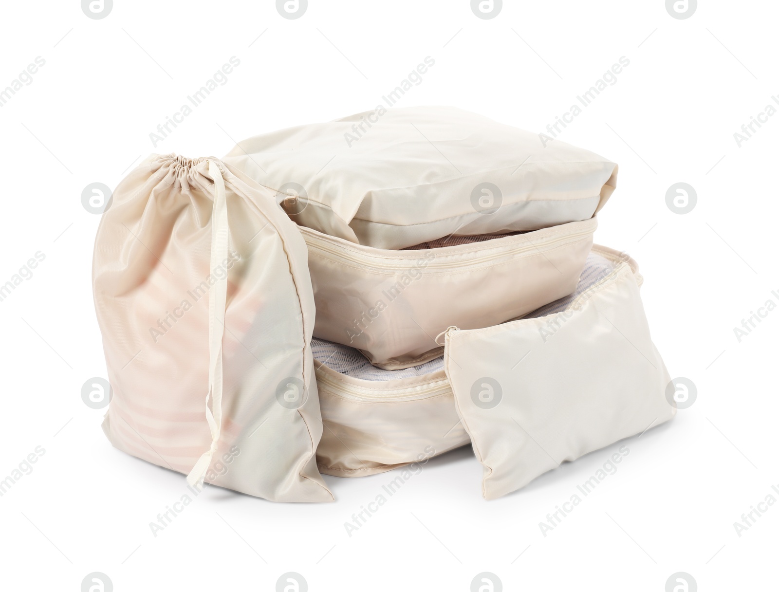 Beige packing cubes with clothes isolated on white Photo of Beige packing cubes with clothes isolated on white