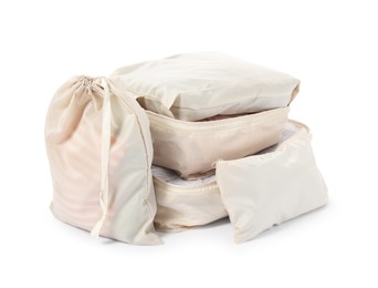 Photo of Beige packing cubes with clothes isolated on white