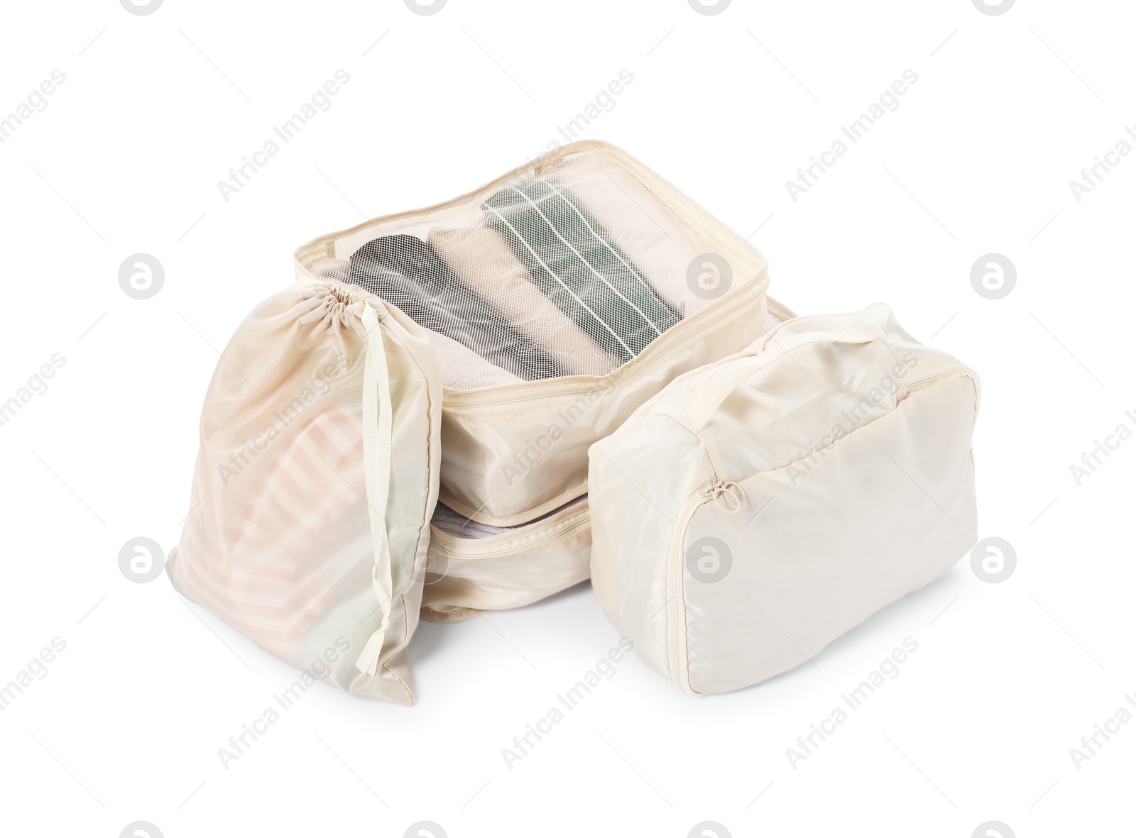 Beige packing cubes with clothes isolated on white Photo of Beige packing cubes with clothes isolated on white