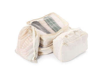 Photo of Beige packing cubes with clothes isolated on white