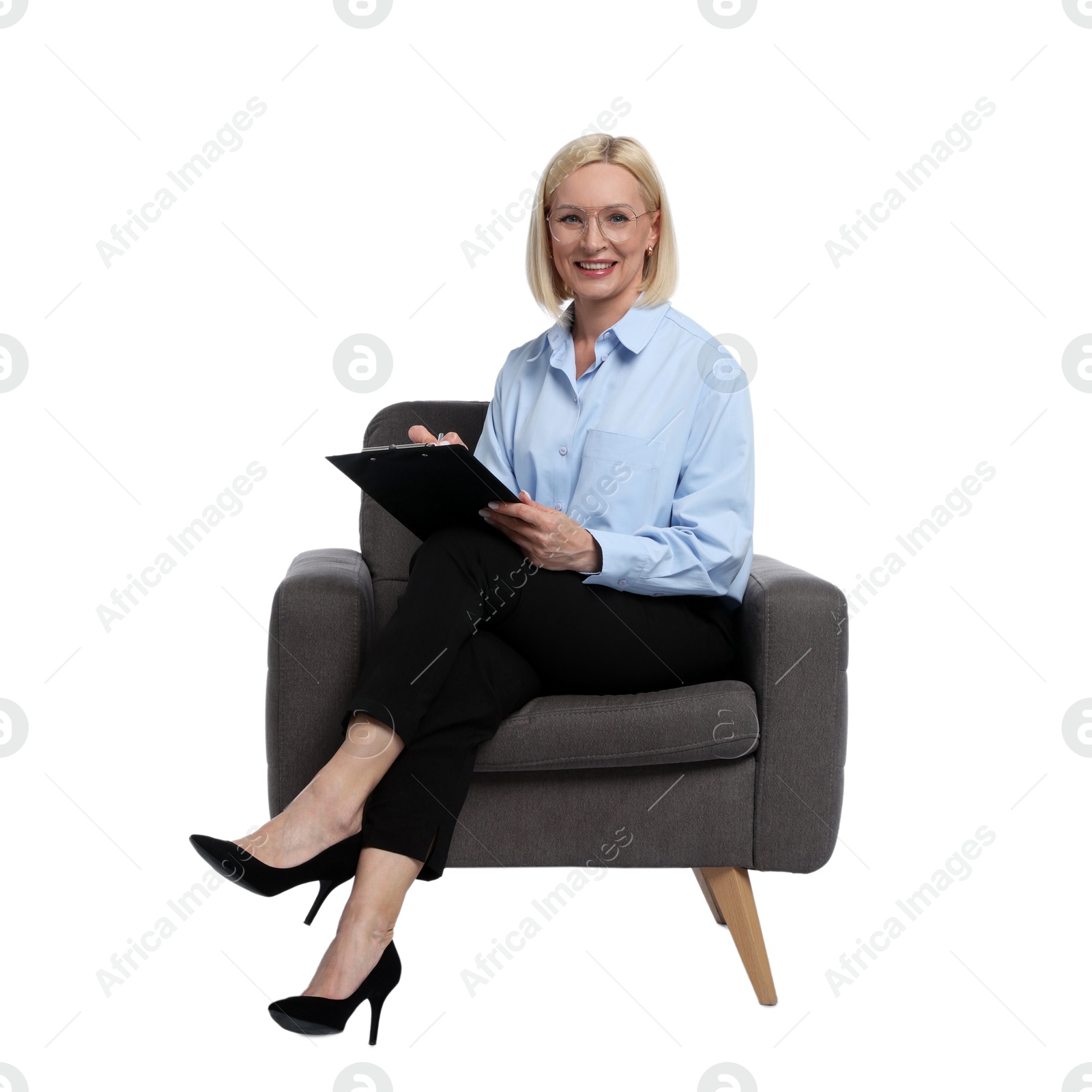 Professional psychologist with clipboard in armchair on white background Photo of Professional psychologist with clipboard in armchair on white background