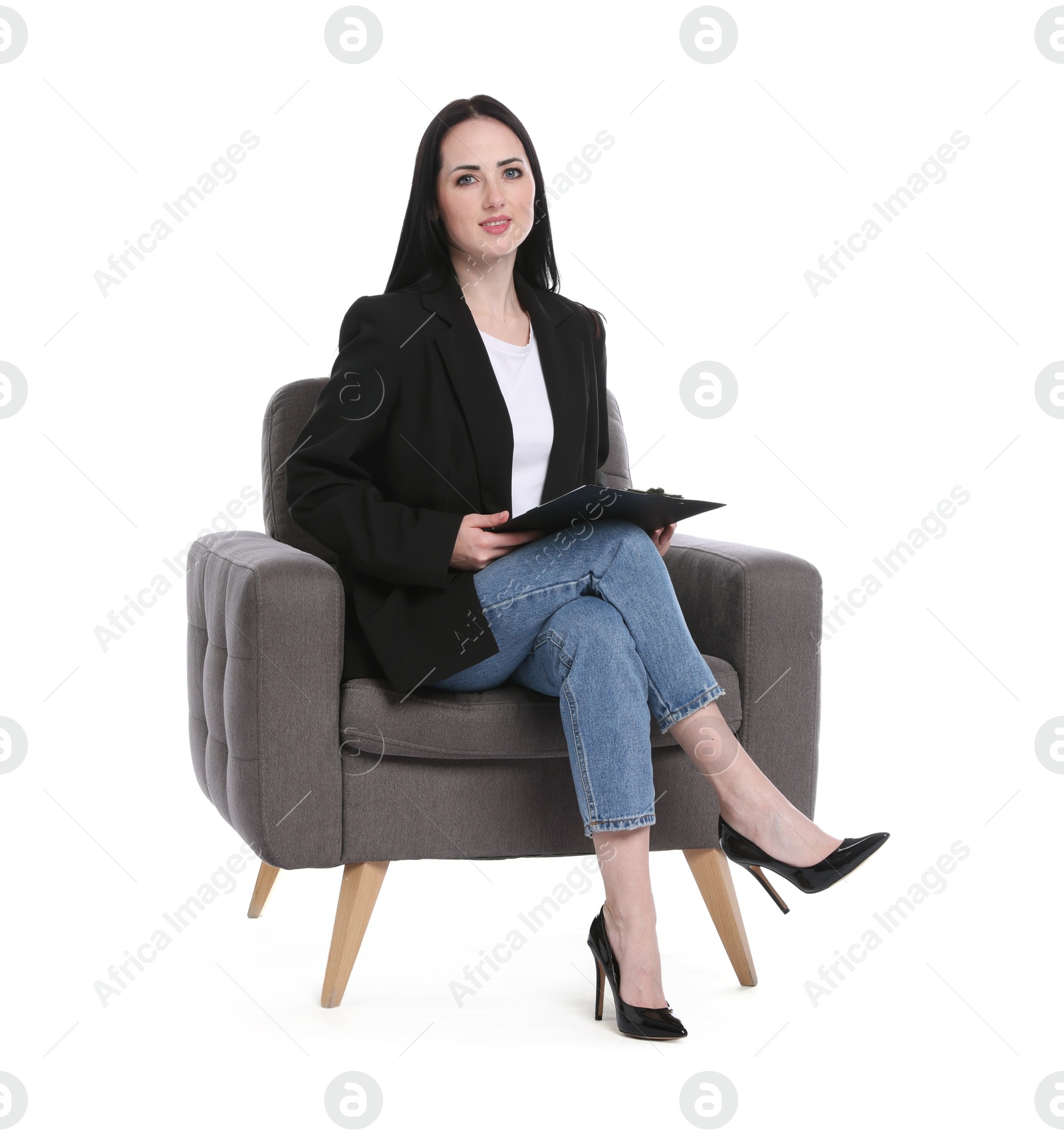 Professional psychologist with clipboard in armchair on white background Photo of Professional psychologist with clipboard in armchair on white background