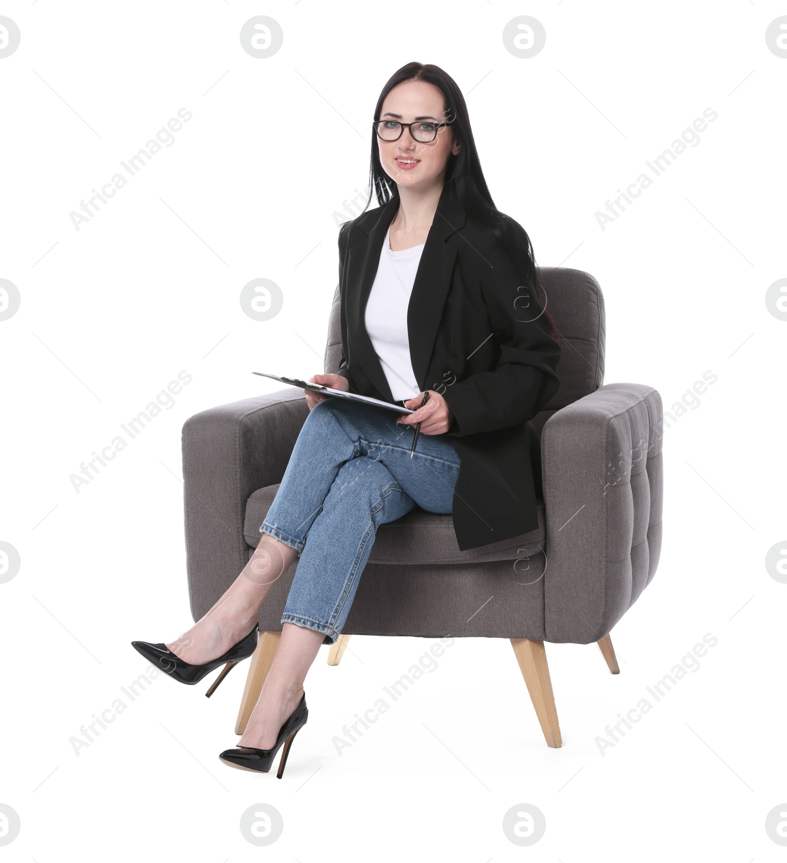 Professional psychologist with clipboard and pen in armchair on white background Photo of Professional psychologist with clipboard and pen in armchair on white background