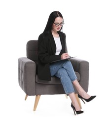 Photo of Professional psychologist with clipboard and pen in armchair on white background