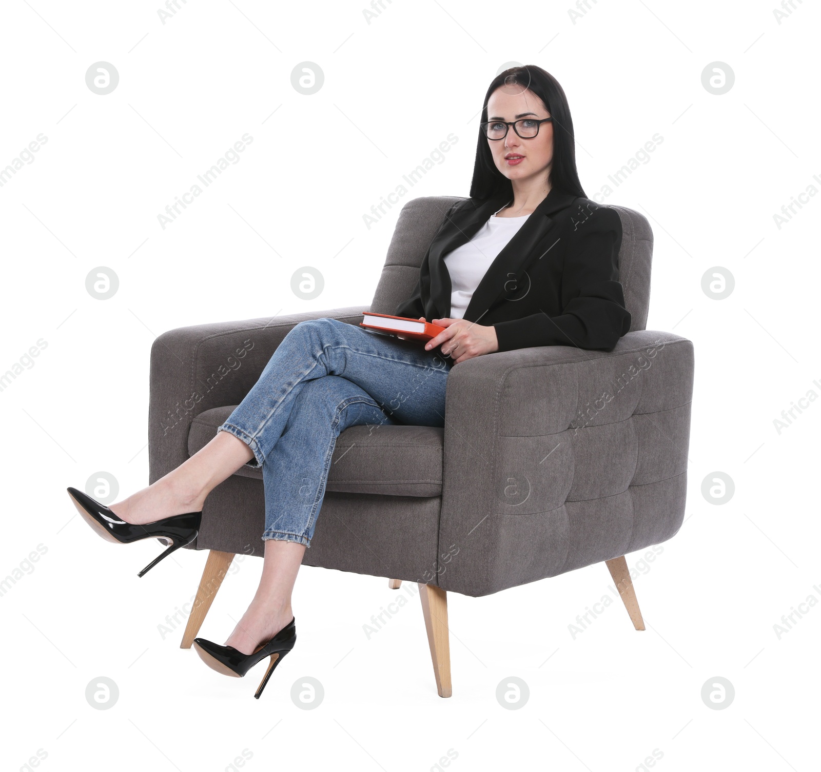 Professional psychologist with notebook in armchair on white background Photo of Professional psychologist with notebook in armchair on white background