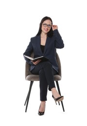 Photo of Professional psychologist with notebook in office chair on white background