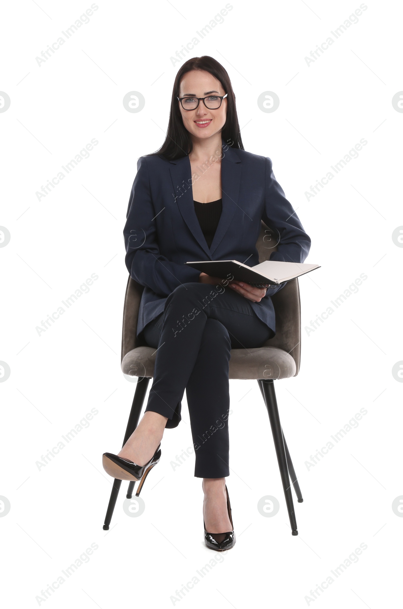 Professional psychologist with notebook in office chair on white background Photo of Professional psychologist with notebook in office chair on white background