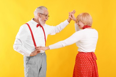 Photo of Lovely senior couple together on yellow background