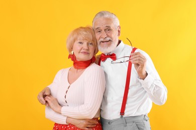 Photo of Lovely senior couple together on yellow background