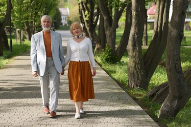 Photo of Lovely senior couple together in park, space for text