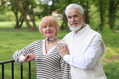 Photo of Lovely senior couple spending time together in park