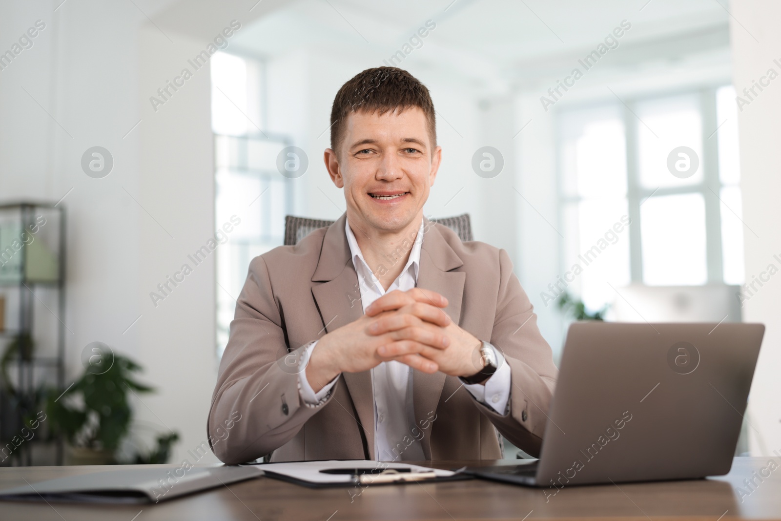 Portrait of handsome man at desk in office Photo of Portrait of handsome man at desk in office