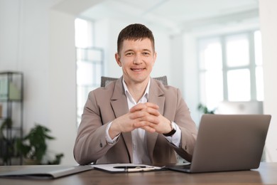 Photo of Portrait of handsome man at desk in office