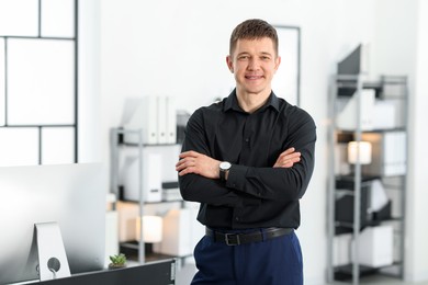 Photo of Portrait of handsome man near desk in office. Space for text