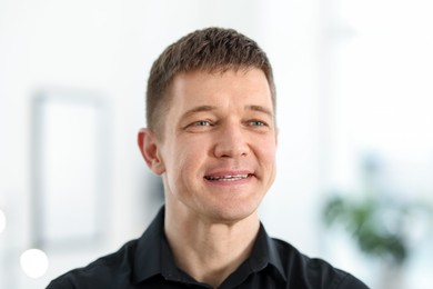 Photo of Portrait of handsome middle aged man indoors