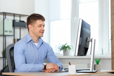 Photo of Portrait of handsome man at desk in office