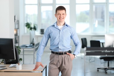 Photo of Portrait of handsome man near desk in office