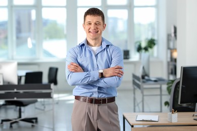 Photo of Portrait of handsome man near desk in office