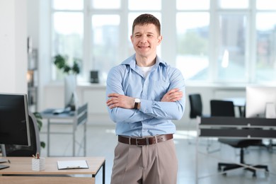 Photo of Portrait of handsome man near desk in office