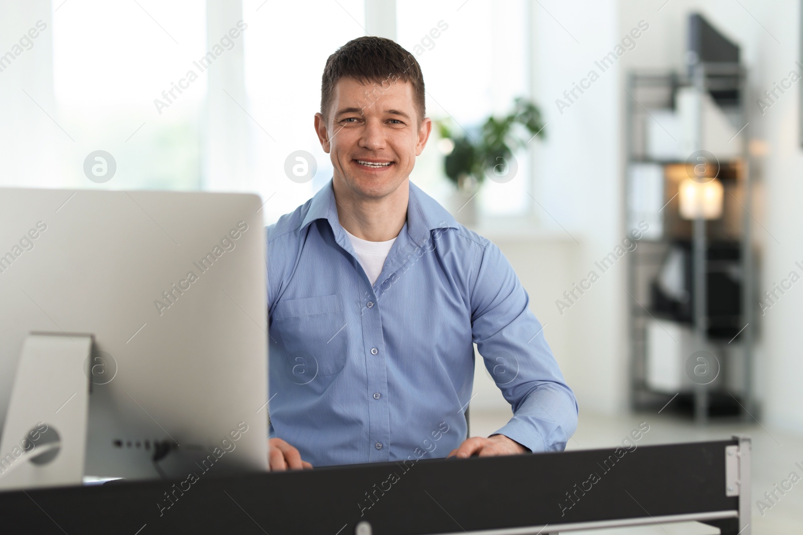 Portrait of handsome man at desk in office Photo of Portrait of handsome man at desk in office