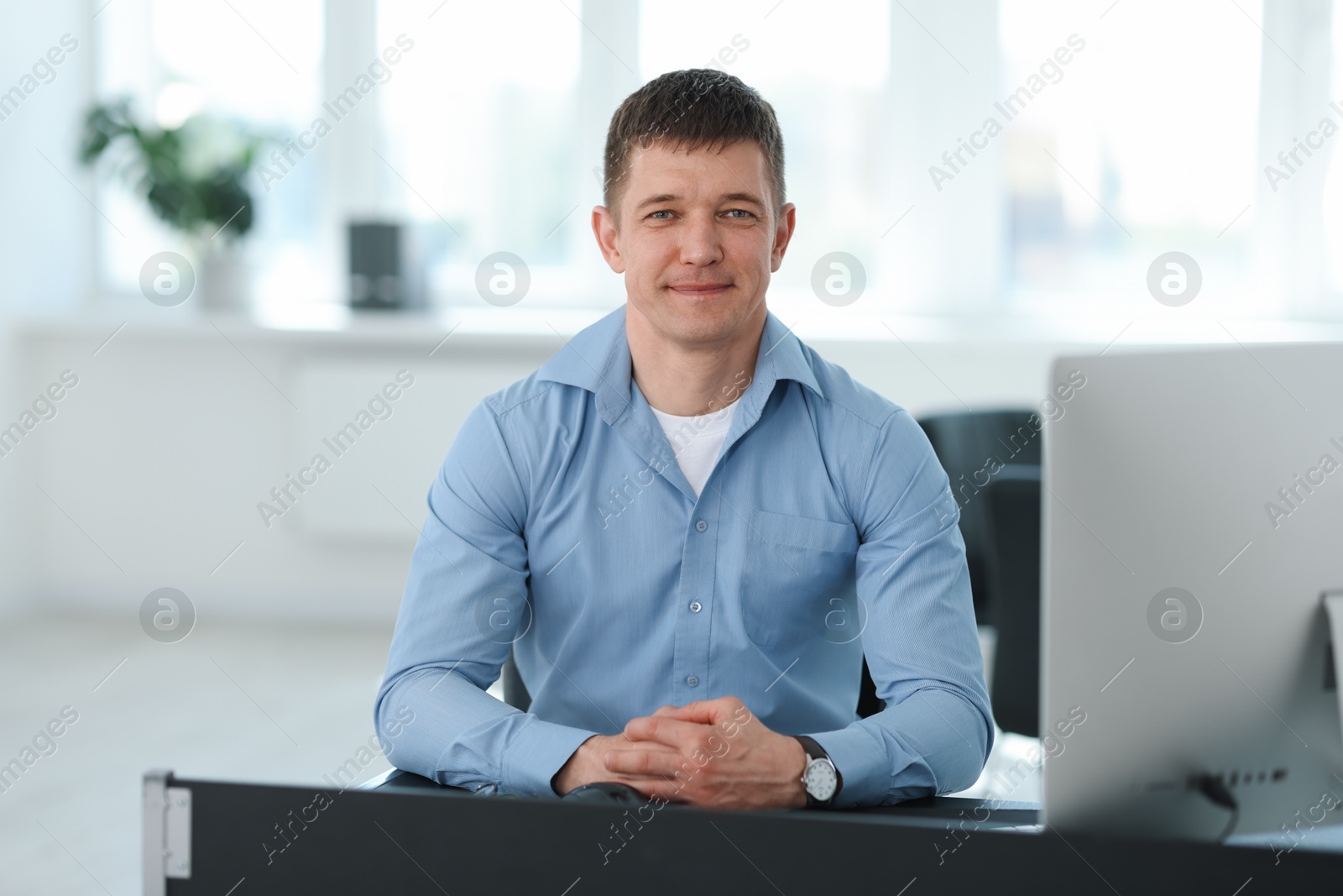 Portrait of handsome man at desk in office Photo of Portrait of handsome man at desk in office