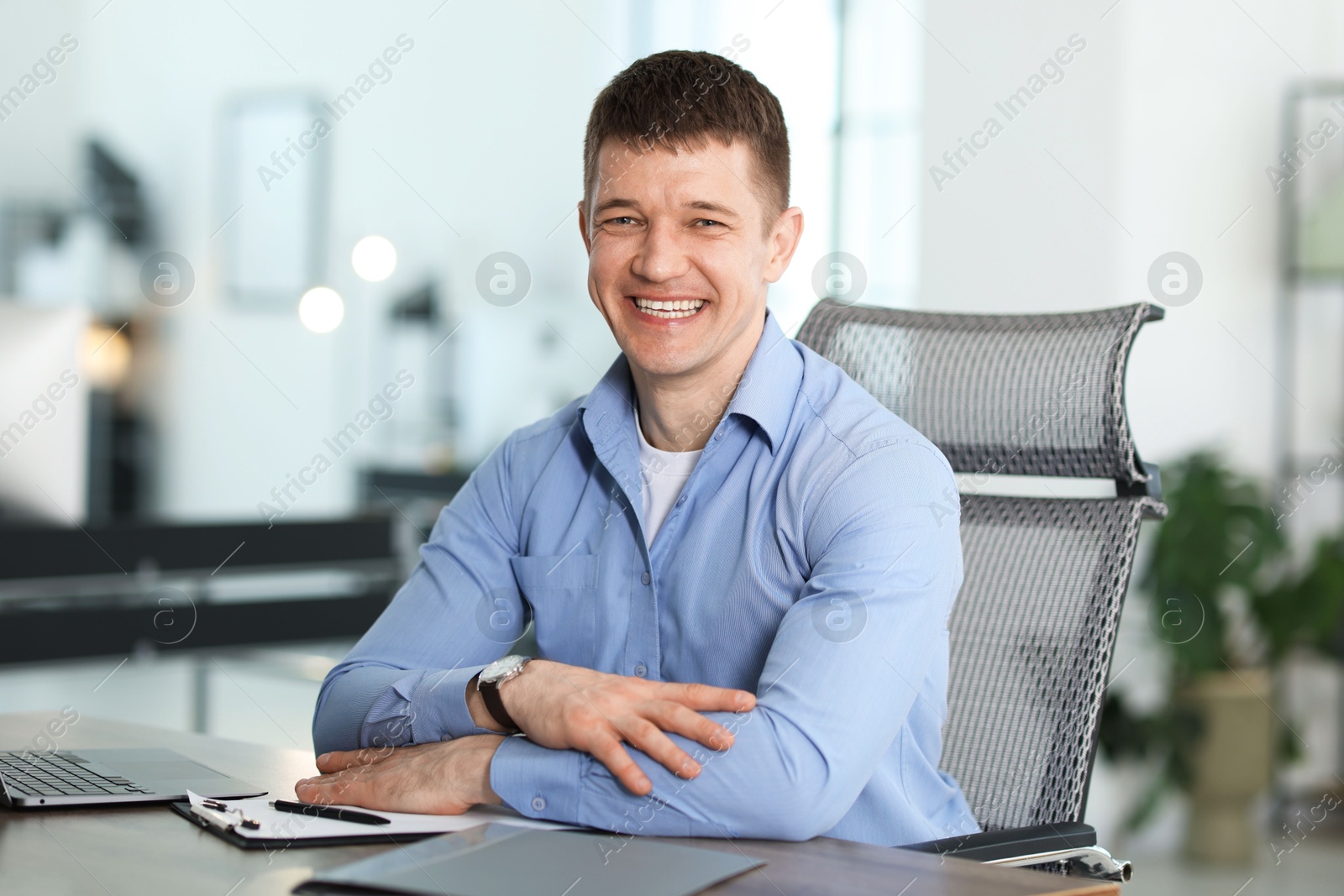 Portrait of handsome man at desk in office Photo of Portrait of handsome man at desk in office