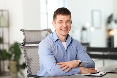 Photo of Portrait of handsome man at desk in office