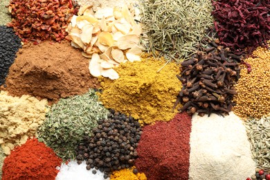 Photo of Many different spices as background, top view