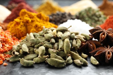 Photo of Many different spices on dark table, closeup