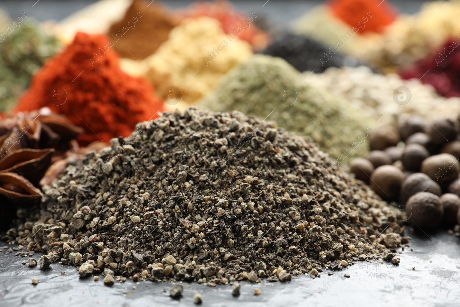Many different spices on dark table, closeup Photo of Many different spices on dark table, closeup