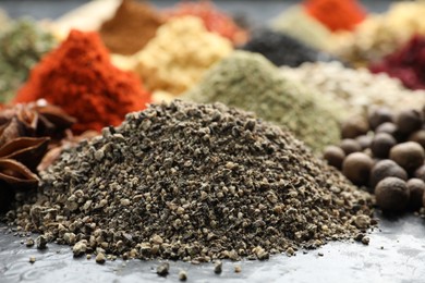 Photo of Many different spices on dark table, closeup