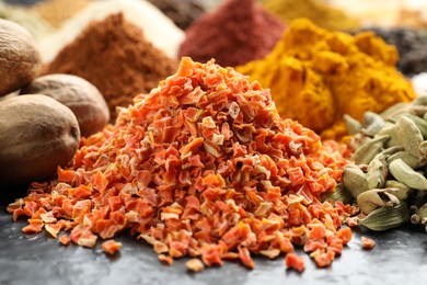 Photo of Many different spices on dark table, closeup