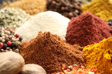 Photo of Many different spices as background, closeup view