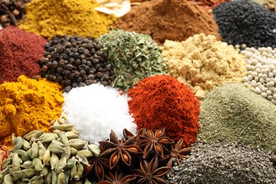 Photo of Many different spices as background, closeup view