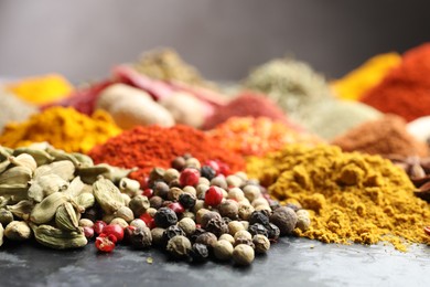 Photo of Many different spices on dark table, closeup