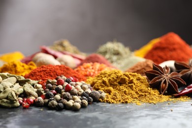 Photo of Many different spices on dark table, closeup