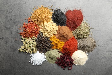 Photo of Many different spices on grey table, flat lay