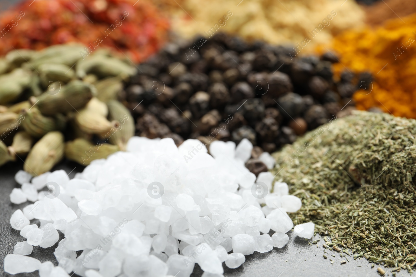 Many different spices on dark table, closeup Photo of Many different spices on dark table, closeup