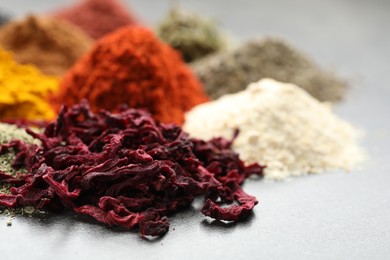 Photo of Many different spices on grey table, closeup