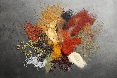Photo of Many different spices on grey table, flat lay