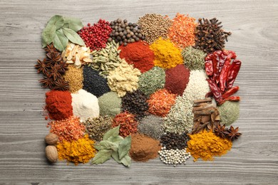 Photo of Many different spices on wooden table, flat lay