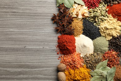 Photo of Many different spices on wooden table, flat lay. Space for text