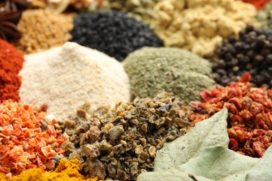 Photo of Many different spices as background, closeup view