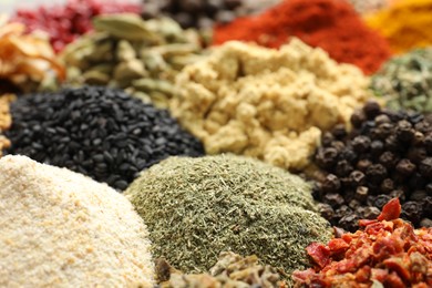 Photo of Many different spices as background, closeup view