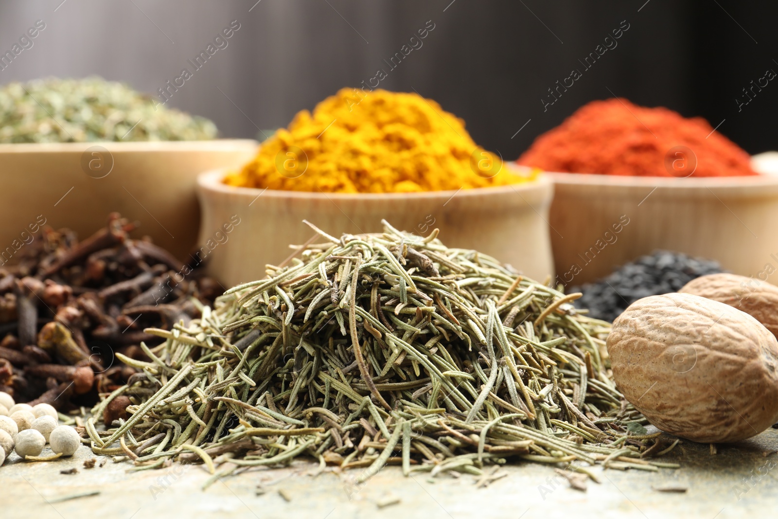 Many different spices on grey table, closeup Photo of Many different spices on grey table, closeup