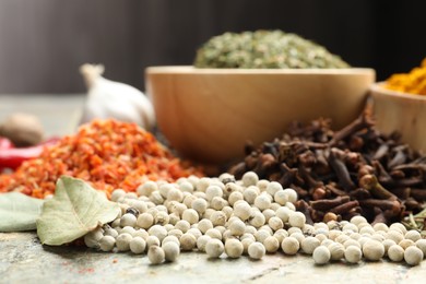 Photo of Many different spices on grey table, closeup