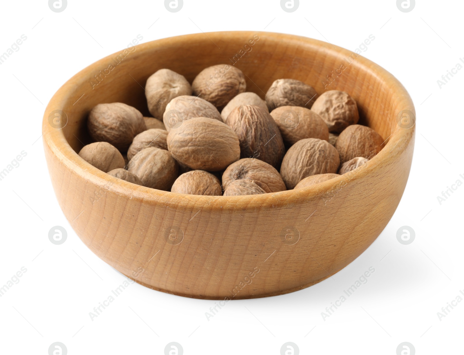 Fresh nutmegs in bowl isolated on white Photo of Fresh nutmegs in bowl isolated on white