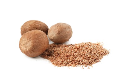 Photo of Whole nutmegs and powder isolated on white