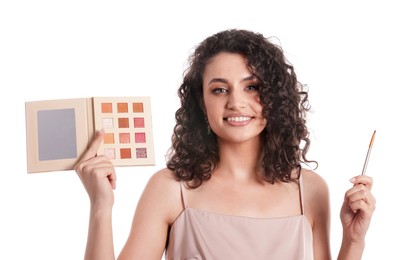Photo of Smiling woman with eyeshadow palette and brush on white background